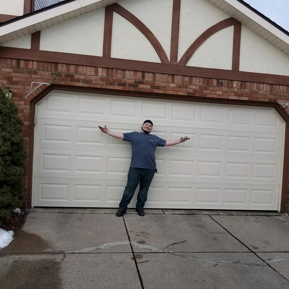 A 24 Hour Door technician in front of new garage door installation